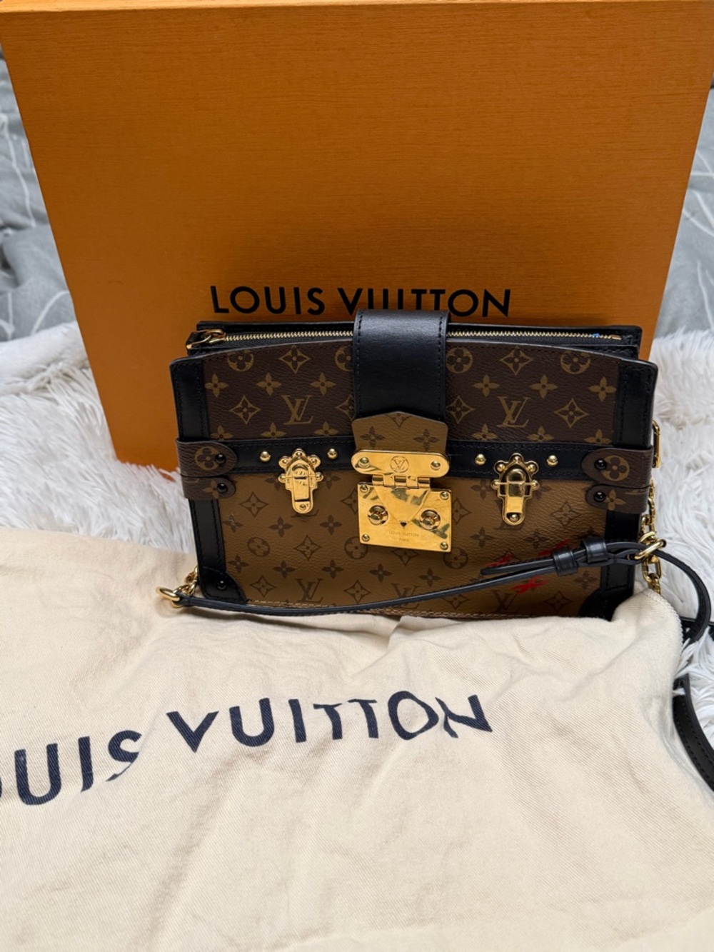 Louis Vuitton reverse monogram trunk pochette bag .